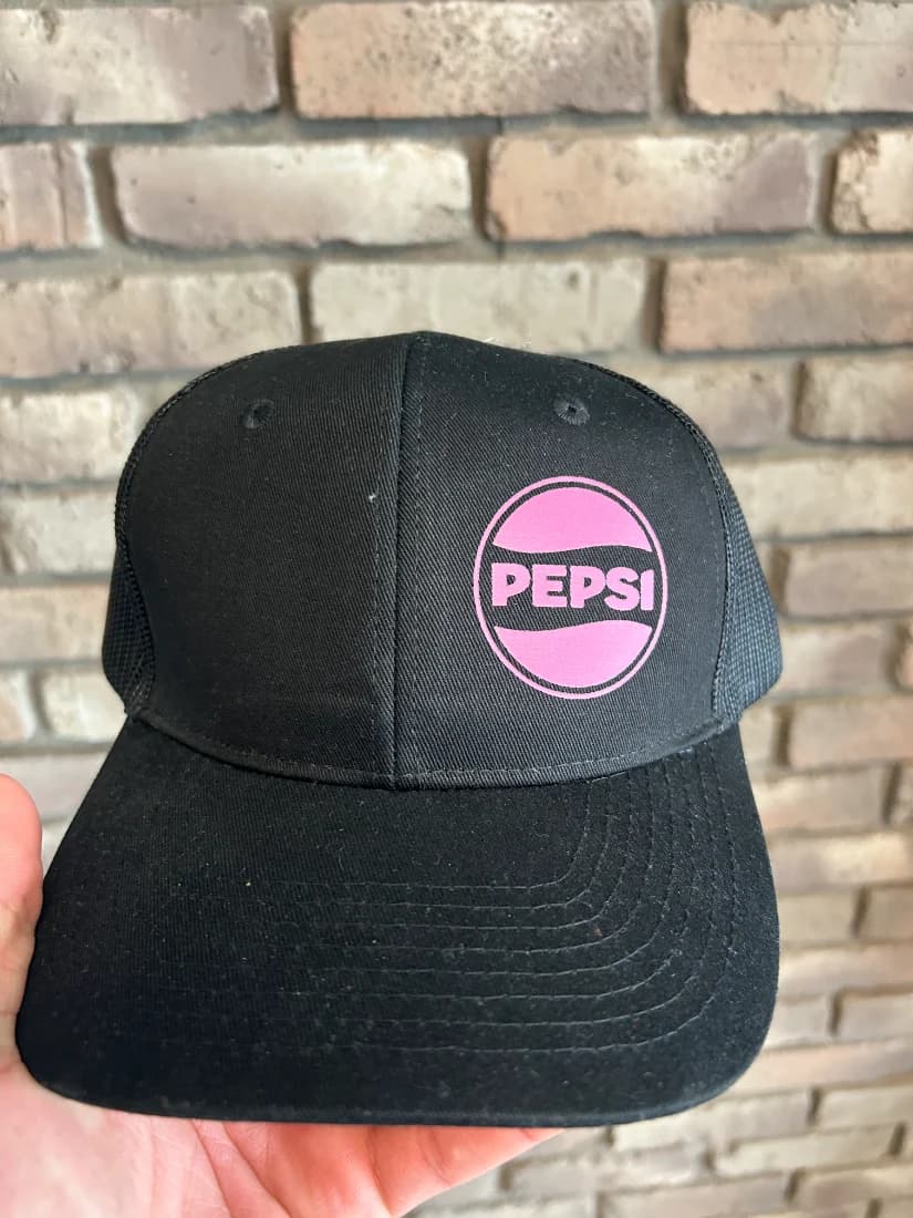 Pepsi pink transfer on black trucker cap