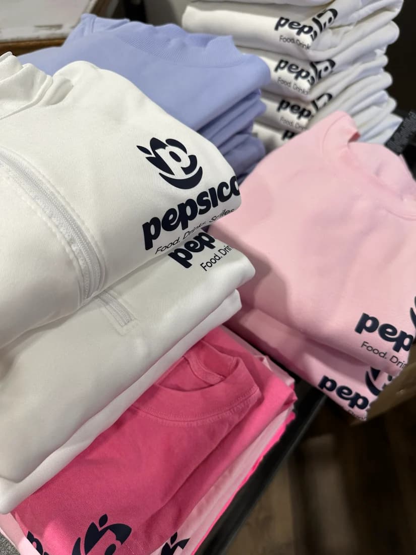 PepsiCo logo fleece and tees, folded stacks